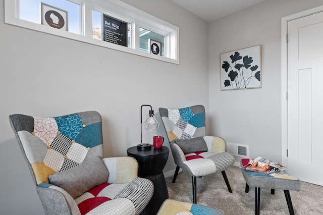 living area featuring carpet flooring and a healthy amount of sunlight