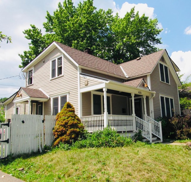 view of front of house featuring a porch and a front yard