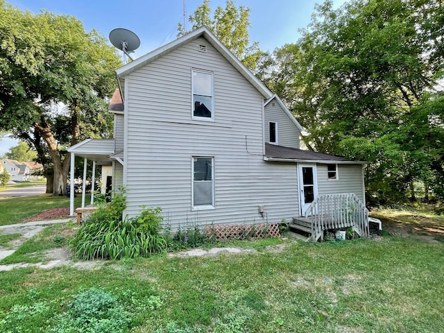 back of house with a lawn