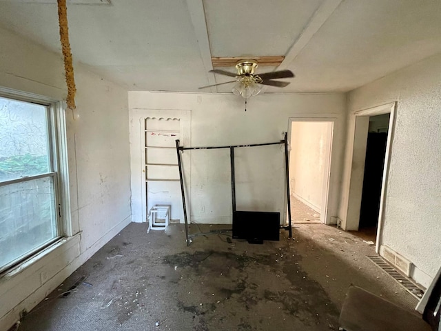 interior space with concrete floors and ceiling fan