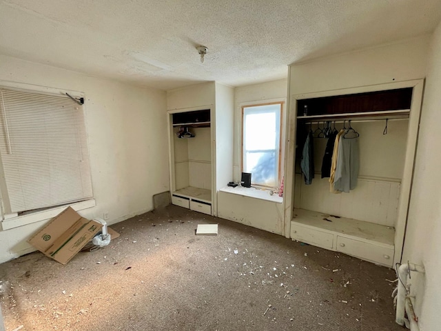 unfurnished bedroom with a textured ceiling