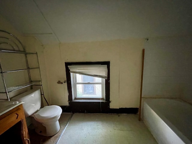 bathroom featuring a bathing tub, vanity, and toilet