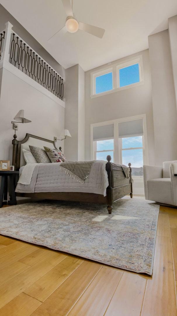 bedroom with hardwood / wood-style flooring and ceiling fan