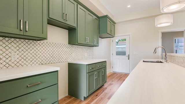 kitchen featuring light hardwood / wood-style floors, green cabinetry, and a wealth of natural light