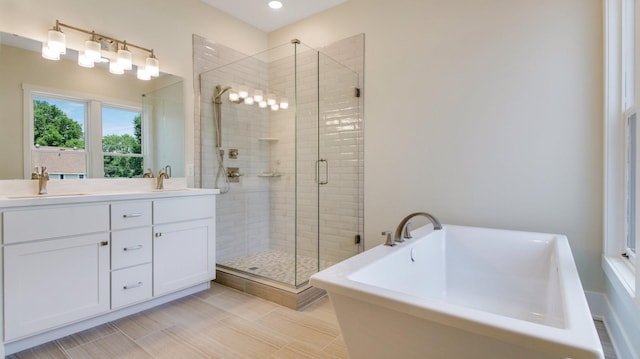 bathroom featuring independent shower and bath and vanity