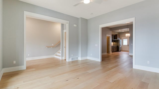 spare room featuring ceiling fan and light hardwood / wood-style flooring