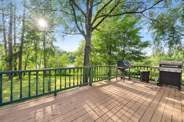 wooden deck featuring a lawn and area for grilling