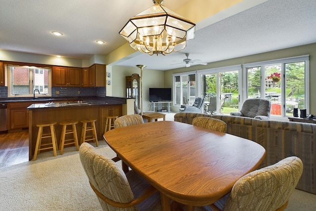 dining room featuring ceiling fan with notable chandelier and hardwood / wood-style floors