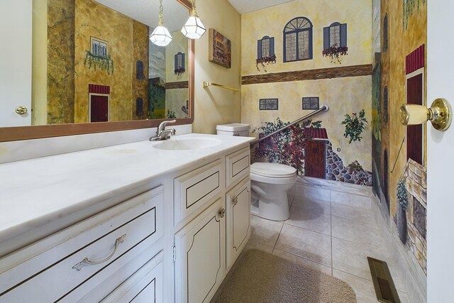 bathroom featuring vanity, a shower, toilet, and tile patterned floors