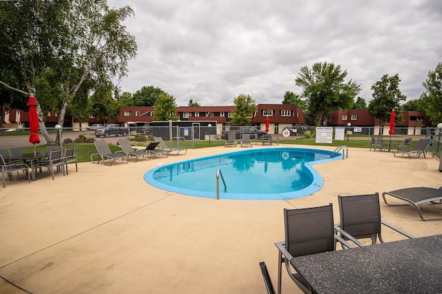 view of swimming pool featuring a patio area