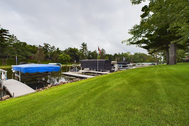 view of yard featuring a dock and a water view