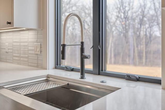 interior details featuring decorative backsplash and light countertops