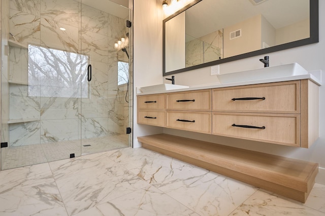 bathroom featuring visible vents, marble finish floor, a sink, a marble finish shower, and double vanity