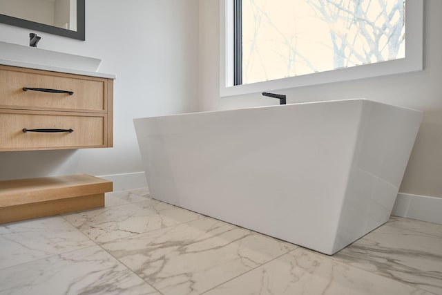 bathroom with baseboards and marble finish floor