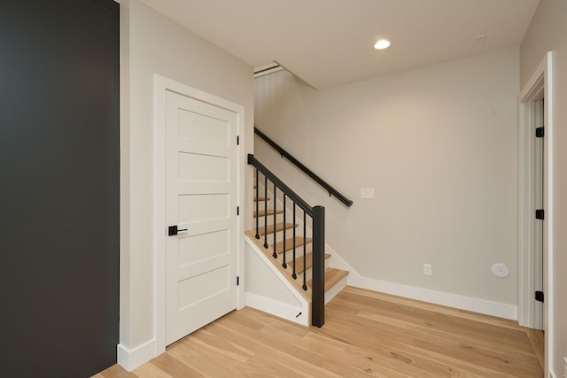 stairs featuring recessed lighting, wood finished floors, and baseboards