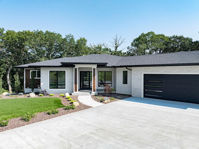 view of front of property featuring a garage and a front lawn