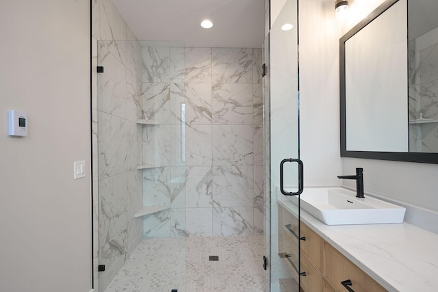 bathroom with vanity, recessed lighting, and a marble finish shower