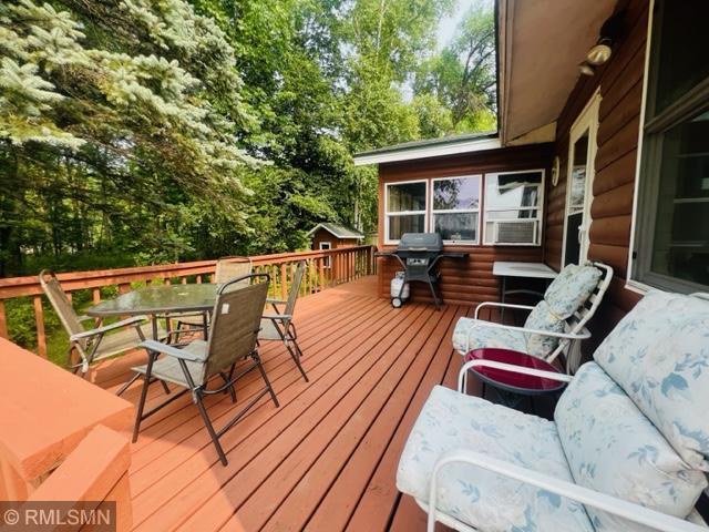 wooden terrace with a grill