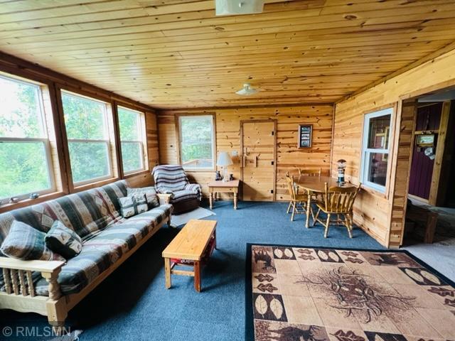 sunroom / solarium featuring wooden ceiling