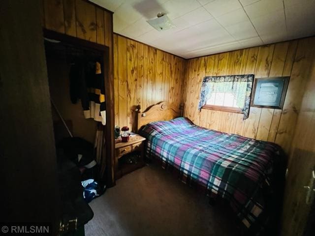 bedroom with wood walls