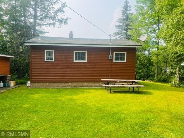 view of side of home featuring a lawn