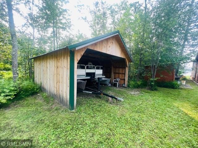 view of outdoor structure with a yard and a garage