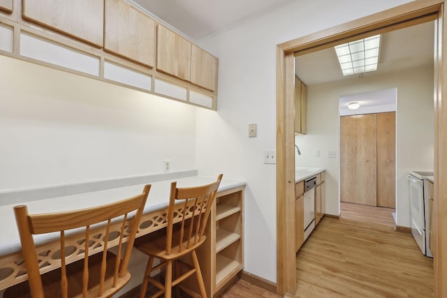 dining space featuring light wood-style floors and baseboards