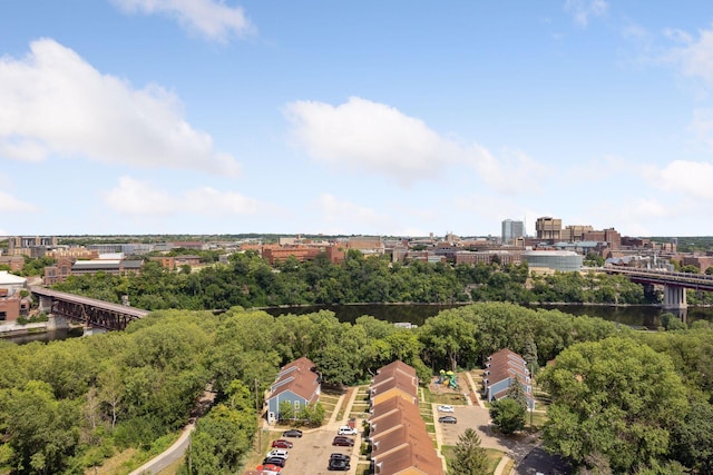 birds eye view of property with a water view and a city view
