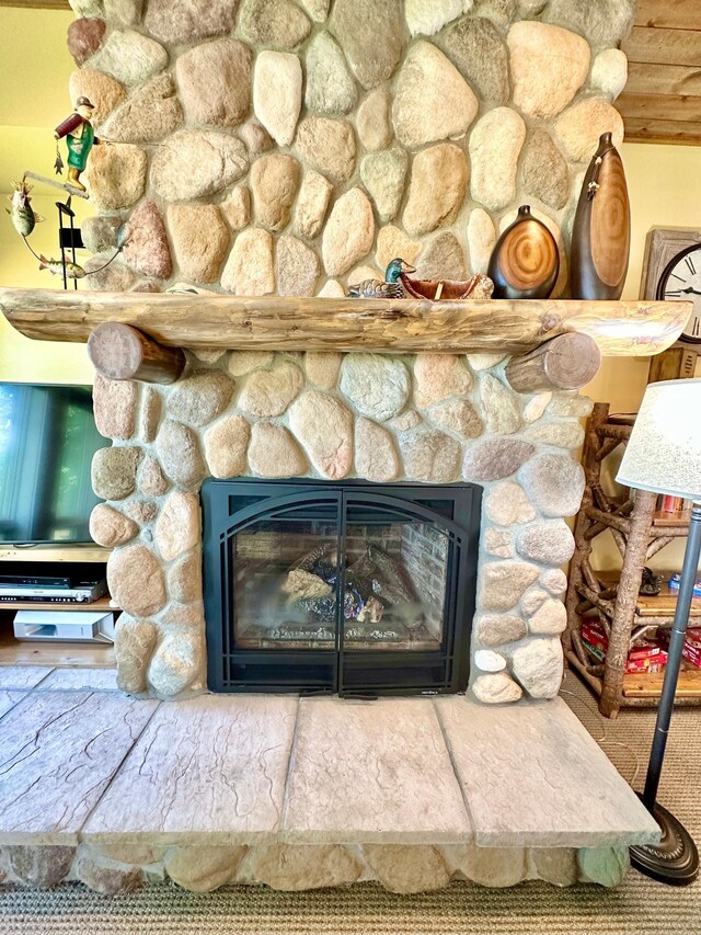 room details featuring a stone fireplace