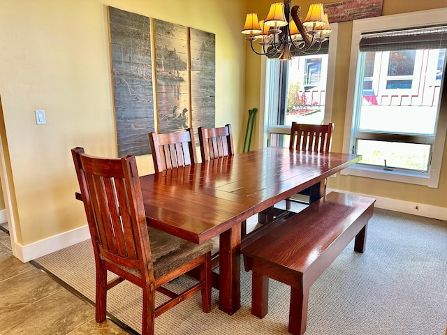 dining room featuring an inviting chandelier and plenty of natural light