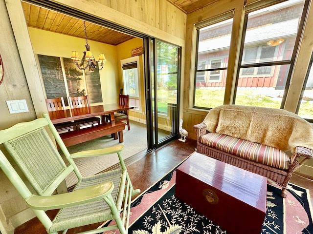 sunroom / solarium with a chandelier, wood ceiling, and plenty of natural light