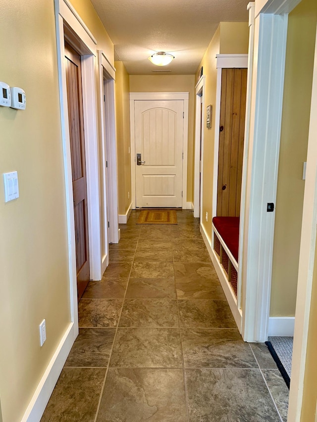 corridor with a textured ceiling