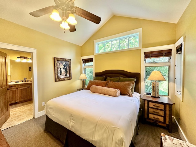 carpeted bedroom featuring ensuite bath, lofted ceiling, sink, and ceiling fan