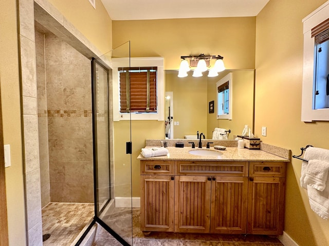 bathroom with vanity and a shower with shower door