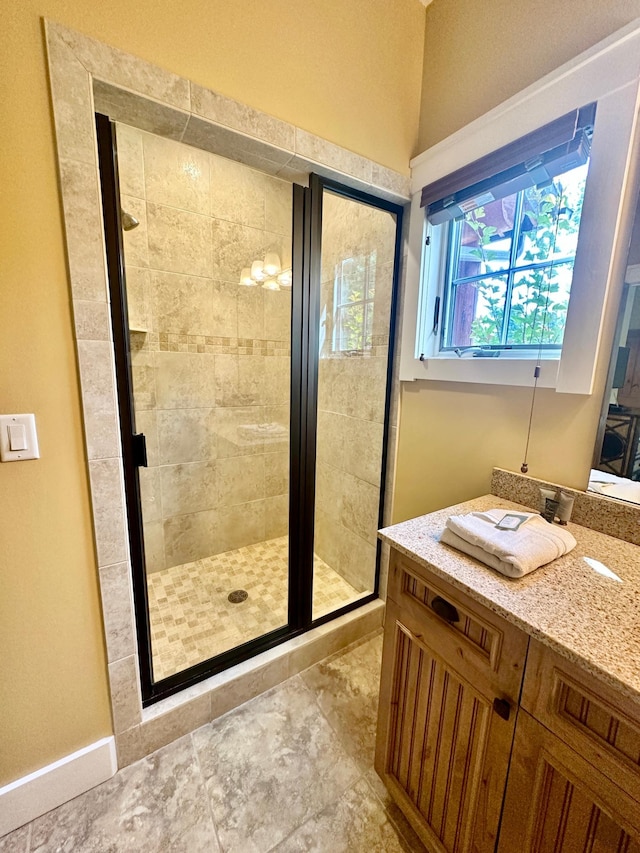 bathroom with vanity and a shower with shower door