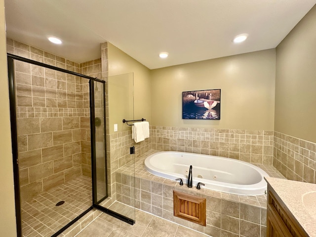 bathroom with vanity, tile patterned floors, and plus walk in shower