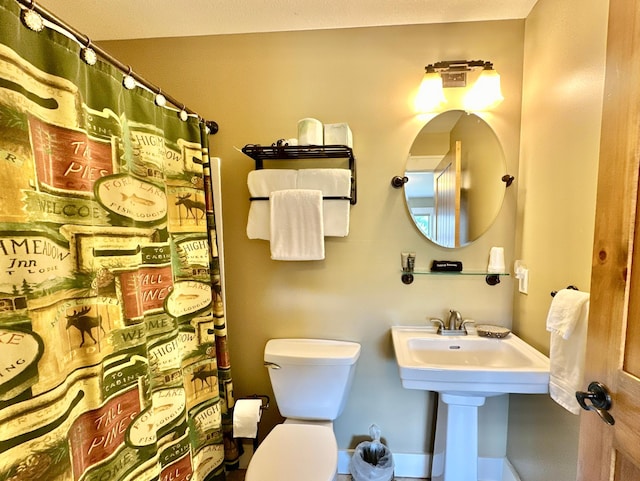 bathroom with toilet and curtained shower