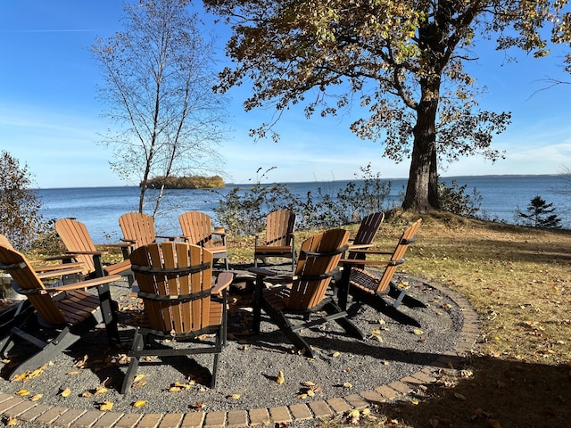 view of patio / terrace featuring a water view and an outdoor fire pit