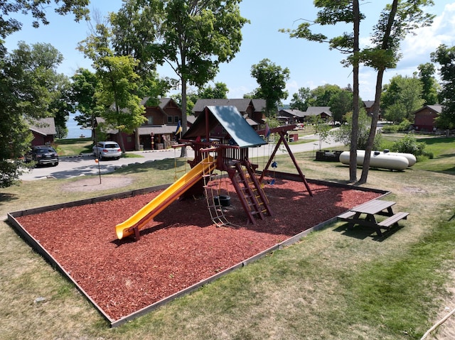 view of jungle gym featuring a lawn