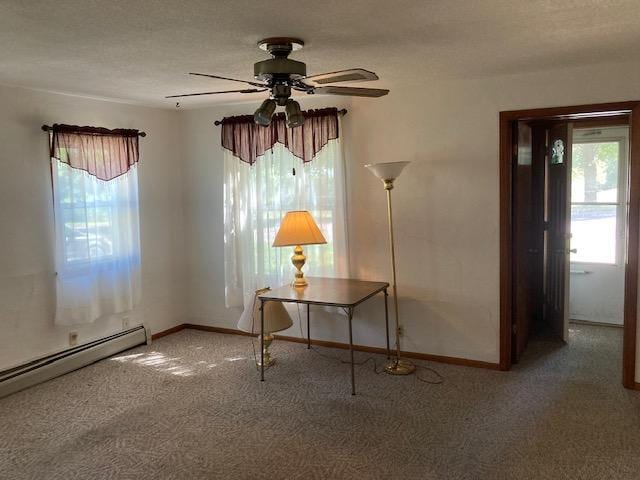 interior space with ceiling fan, a textured ceiling, baseboard heating, and carpet