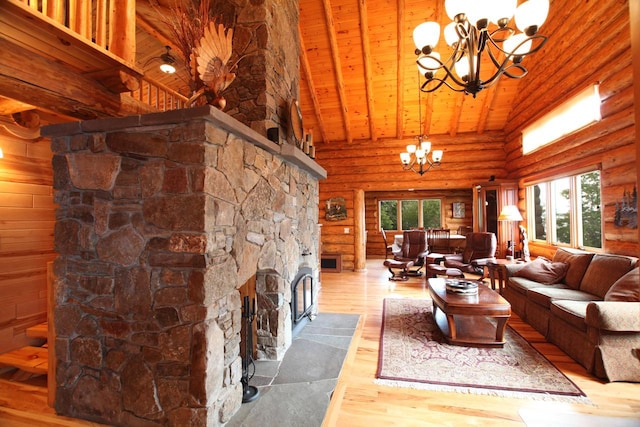 living room featuring a stone fireplace, a notable chandelier, wood-type flooring, wood ceiling, and rustic walls