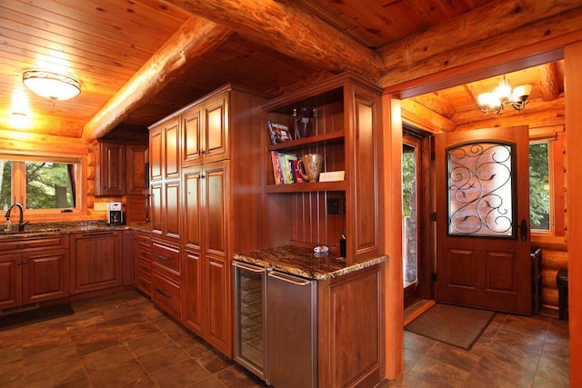 kitchen featuring an inviting chandelier, dark stone countertops, dark tile flooring, and wooden ceiling