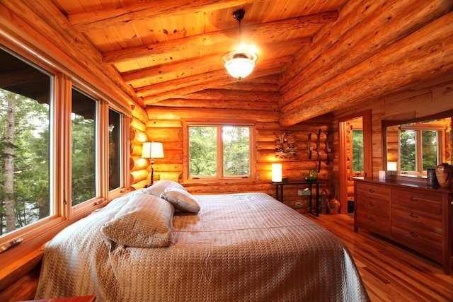 bedroom with lofted ceiling, rustic walls, hardwood / wood-style flooring, and wooden ceiling