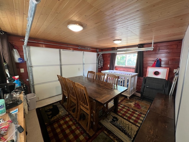 dining room with wood ceiling and wood walls