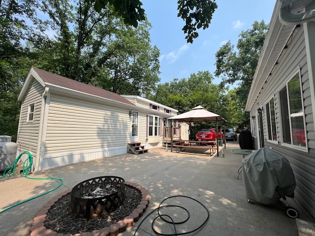 view of terrace featuring a fire pit, a gazebo, grilling area, and a deck