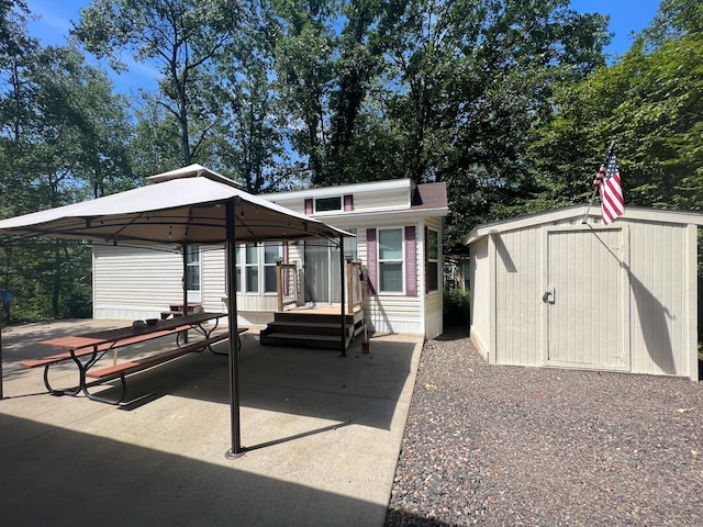 view of front of house featuring a patio, a shed, and a gazebo