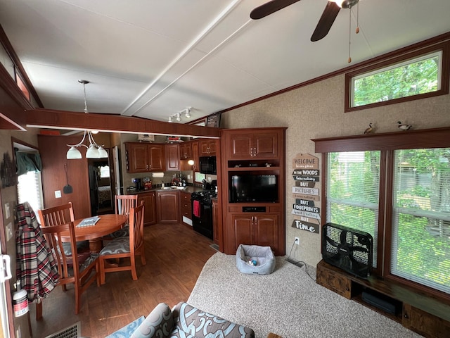 dining room with lofted ceiling with beams, dark hardwood / wood-style floors, and ceiling fan