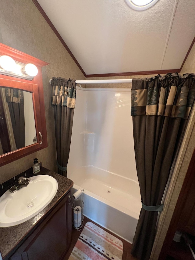 bathroom featuring vanity, shower / bath combination with curtain, and a textured ceiling