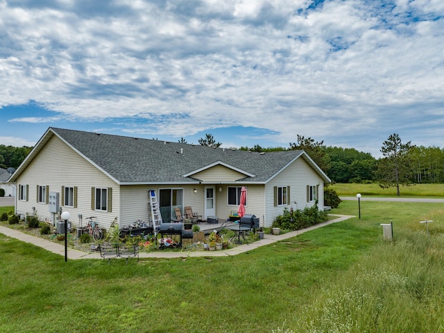 exterior space with a front yard and a patio area