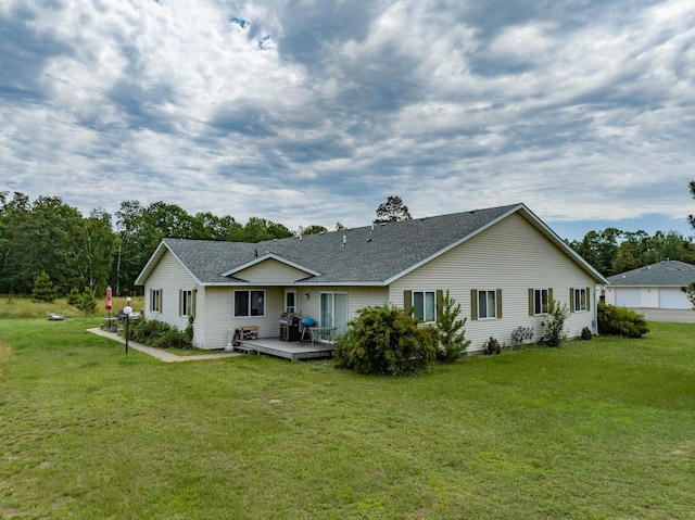 back of house with a deck and a yard